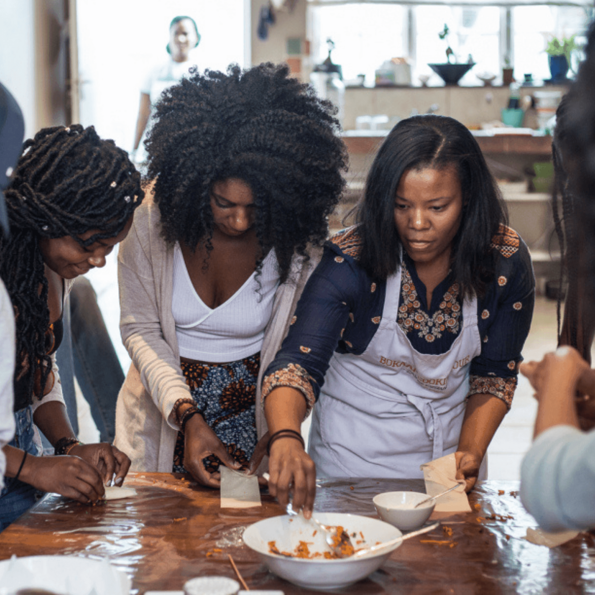 Ladies doing a home-based cooking class