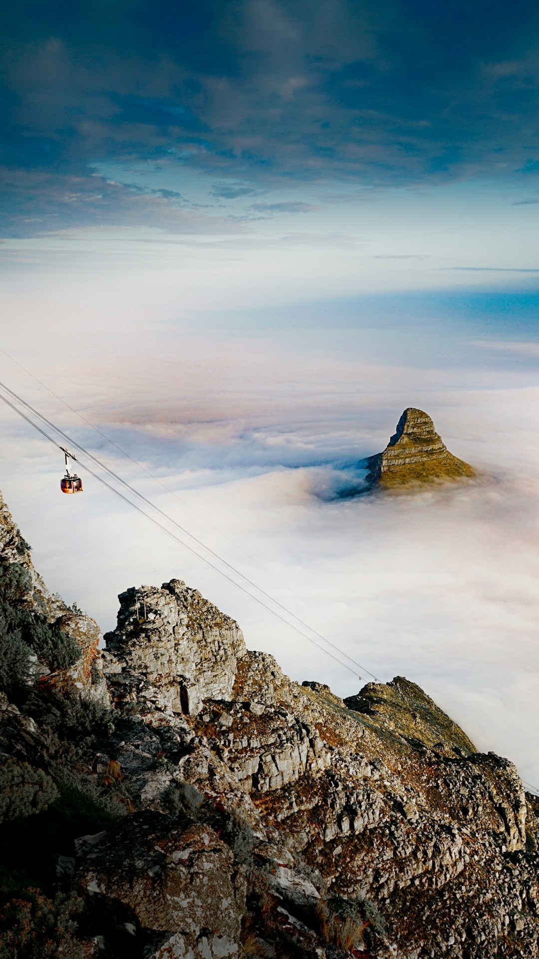 Aerial view of the head of Lions Head and the Table Mountain Cable Car on a cloudy day
